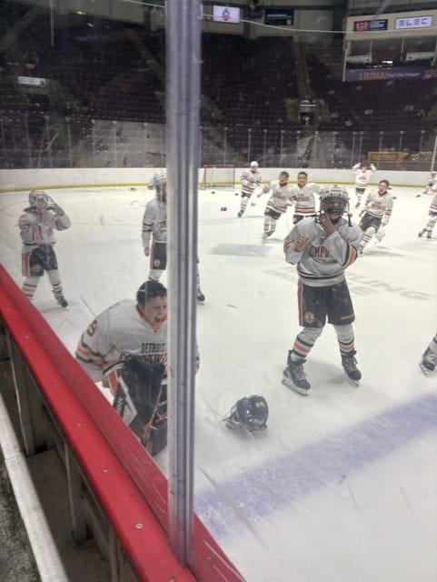 Compuware players celebrate on the ice moments after the final buzzer